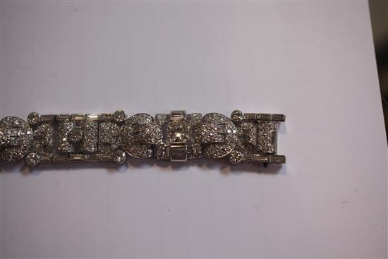 An attractive 1930s/1940s Art Deco white gold and diamond encrusted bracelet in Jays of London fitted box, 7in.